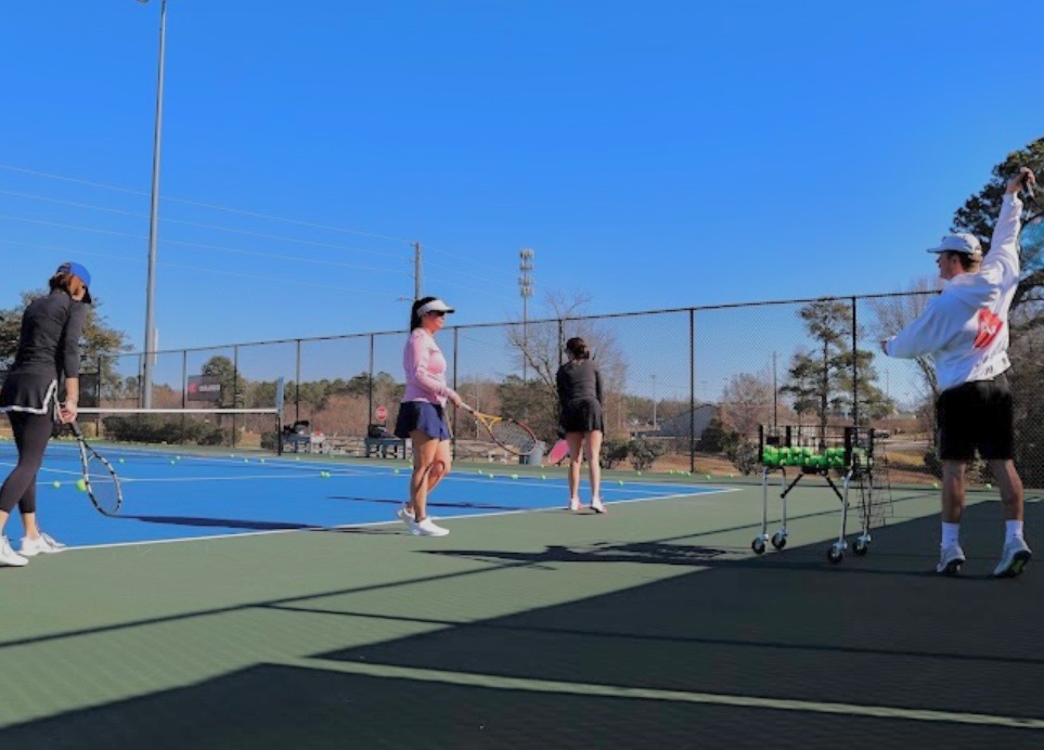 Adults hitting in a coached ATA clinic