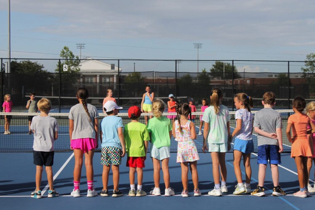 A big group of summer campers lined up at the net